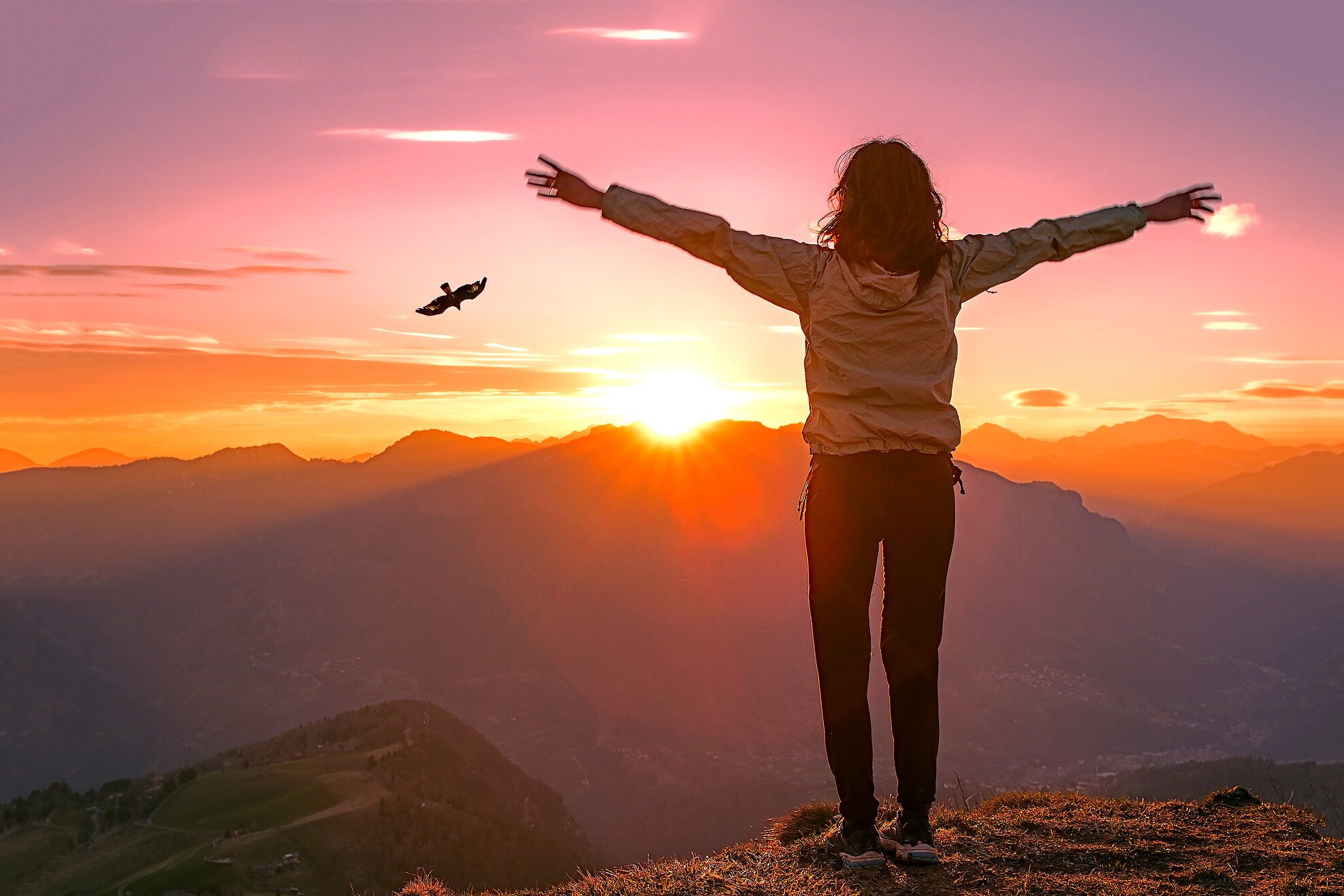 Woman on Top of a Mountain at Sunset Looks Eagle